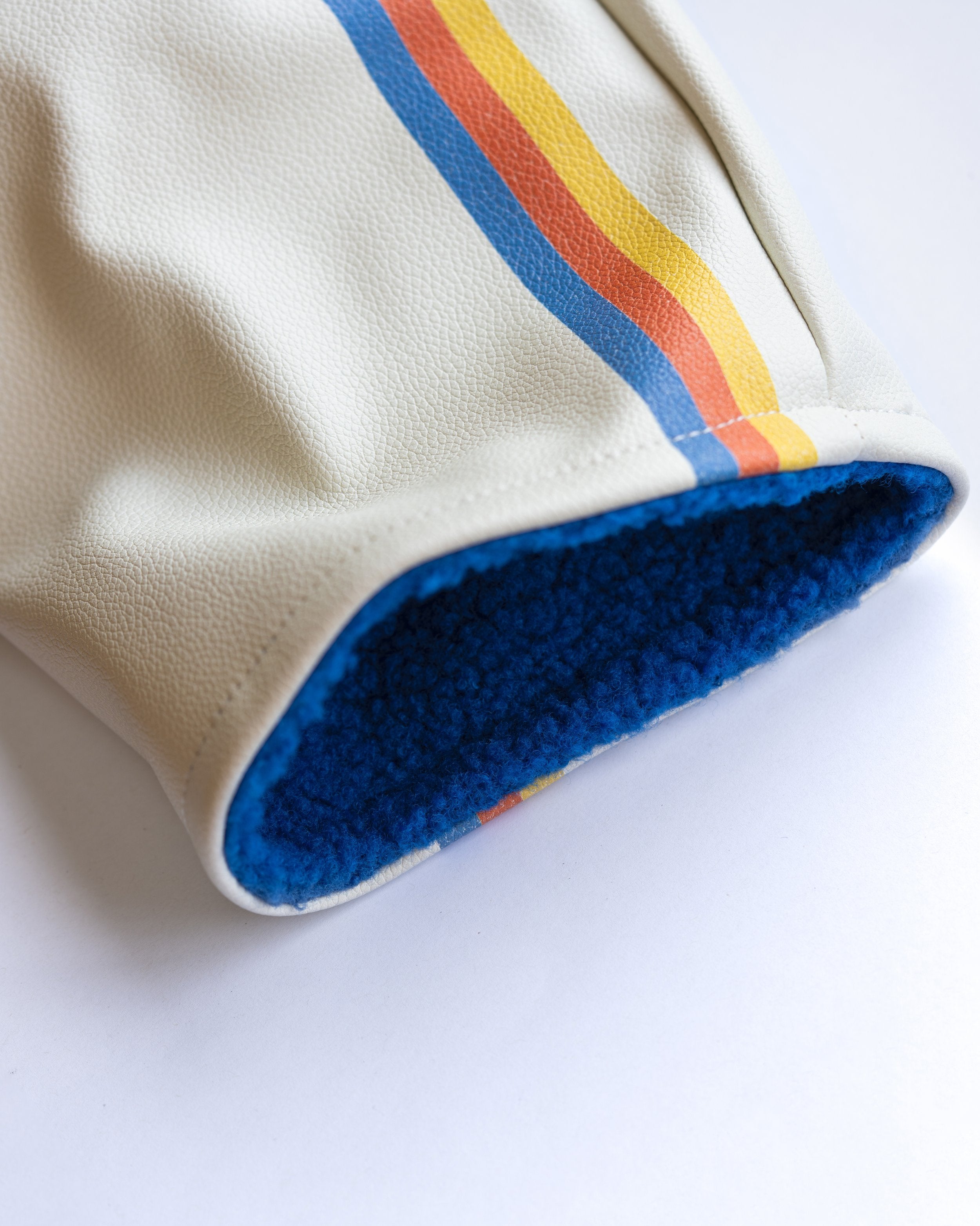Golf Driver Head Cover in cream with blue, orange and yellow details.