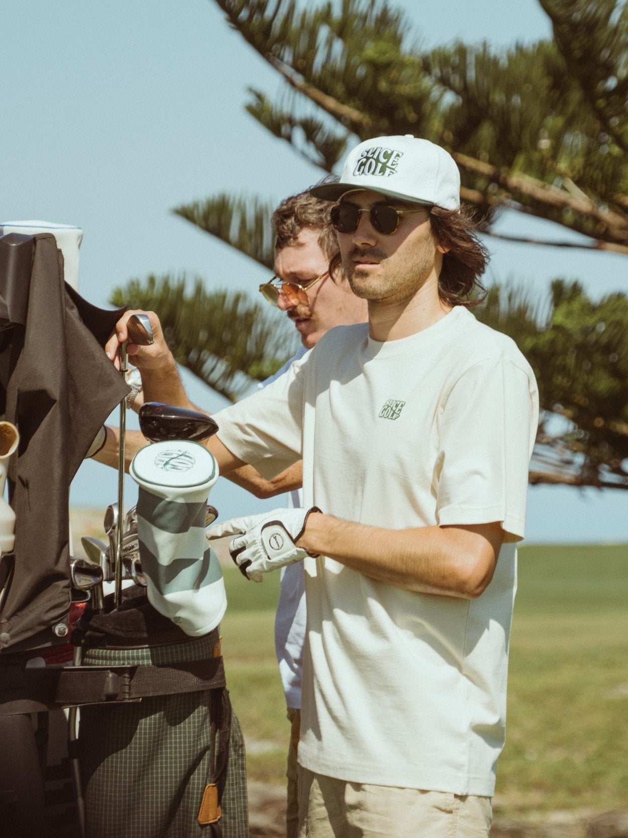 Golf T-shirt in off-white with Slice Golf Logo on model