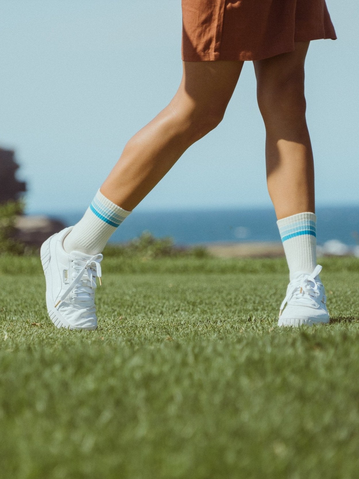Golf sports socks in white with blue stripes on model.