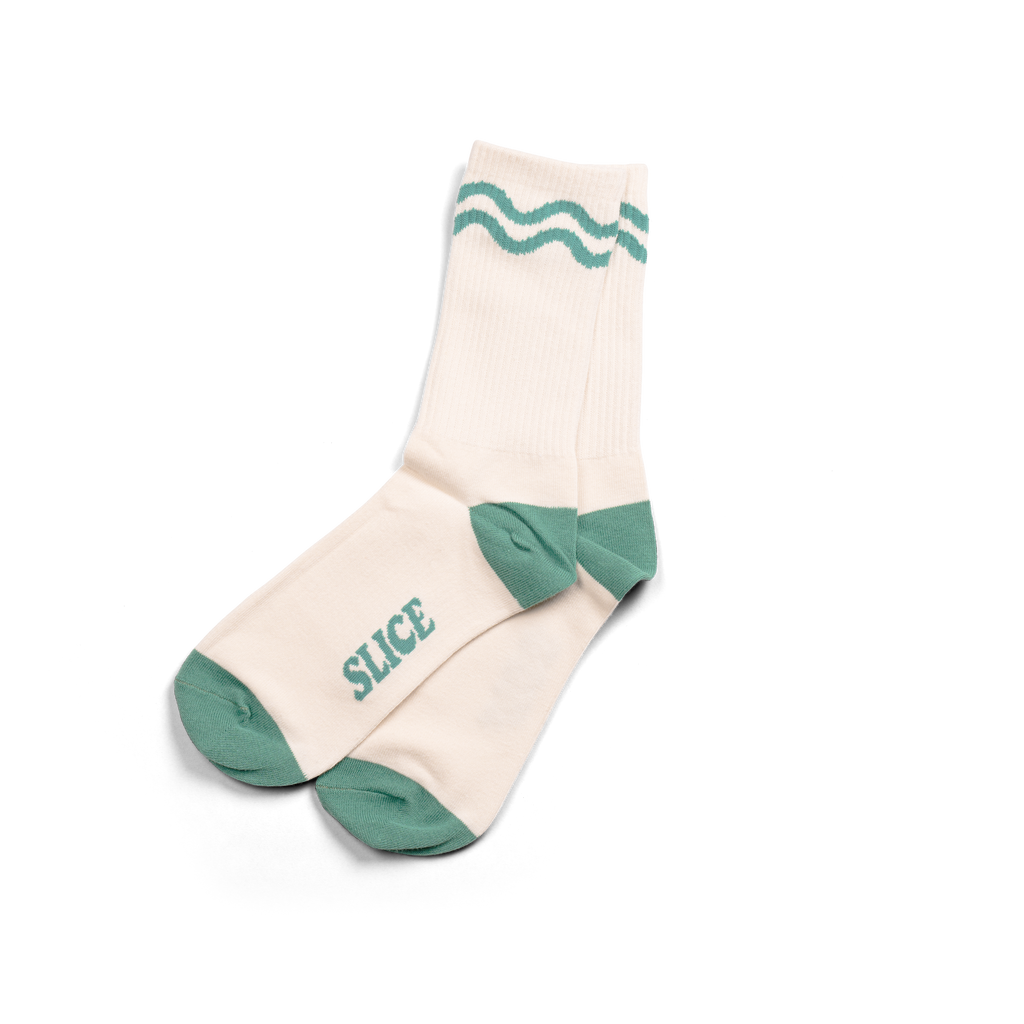 Golf sports socks in off-white and green with green wavy lines.