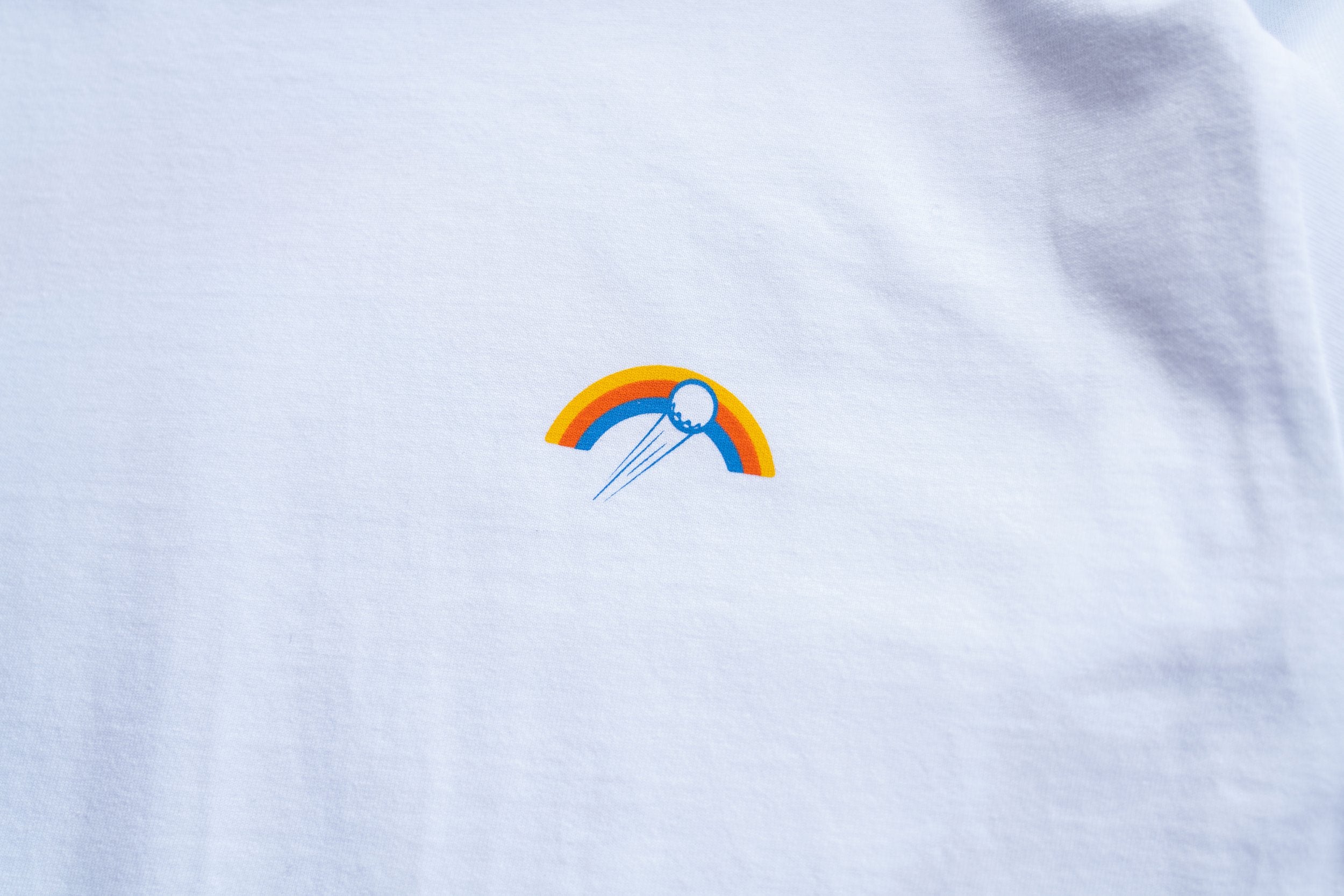 Golf T-shirt in white with Slice Golf Rainbow logo on left chest - front.