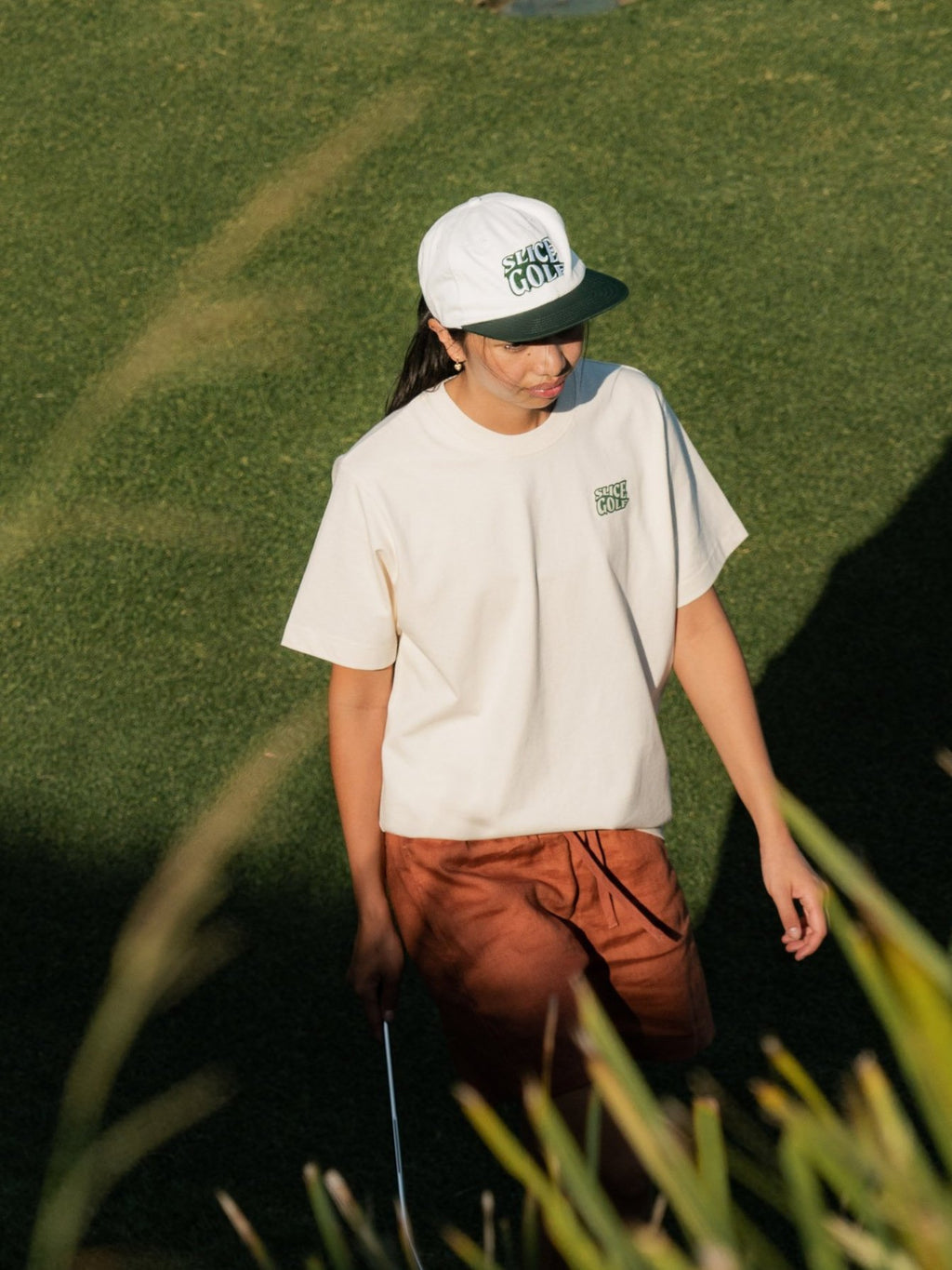 Golf T-shirt in off-white with Slice Golf Logo on model